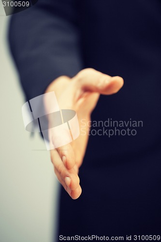 Image of man in suit with an open hand