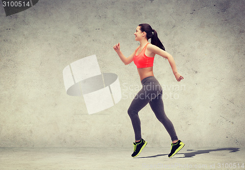 Image of sporty woman running or jumping
