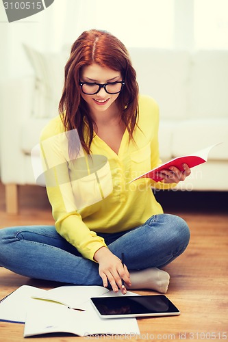 Image of student with tablet pc computer and notebooks