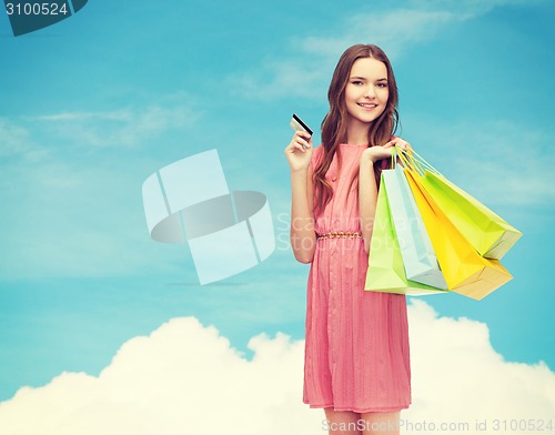 Image of smiling woman in dress with many shopping bags