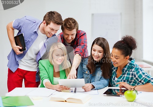 Image of students looking at tablet pc at school