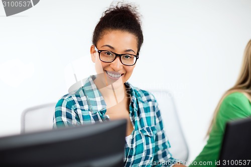 Image of african student with computer studying at school