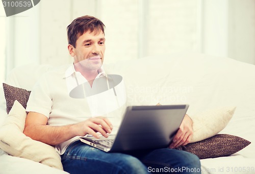 Image of man working with laptop at home