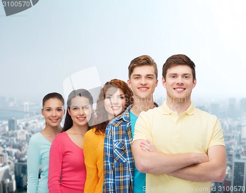 Image of group of smiling teenagers over city background