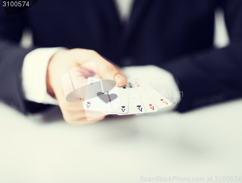 Image of man hand showing four aces