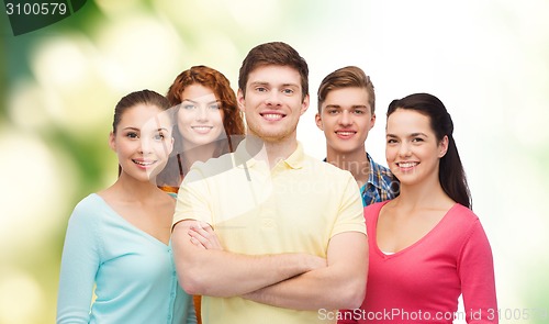 Image of group of smiling teenagers over green background