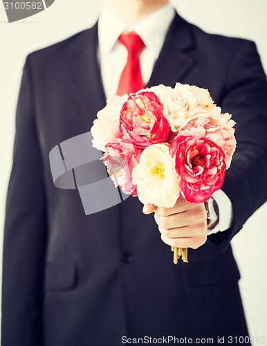 Image of man giving bouquet of flowers