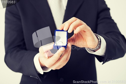 Image of man with gift box and wedding ring