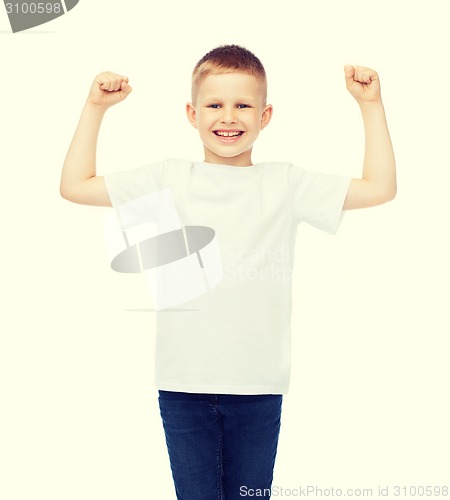 Image of little boy in blank white t-shirt showing muscles