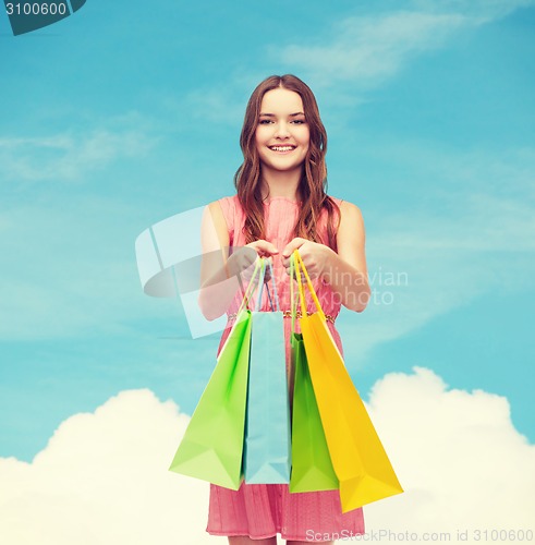 Image of smiling woman in dress with many shopping bags