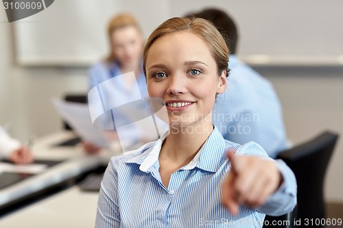 Image of smiling businesswoman pointing finger on you