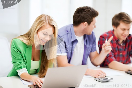 Image of students writing test or exam in lecture at school