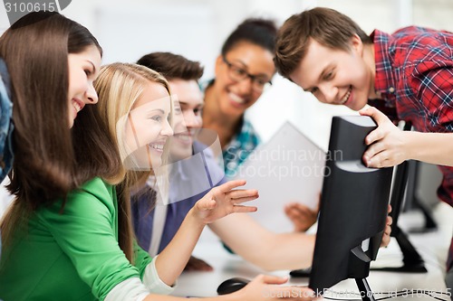 Image of students looking at computer monitor at school