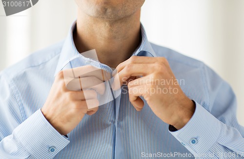 Image of close up of man in shirt dressing 