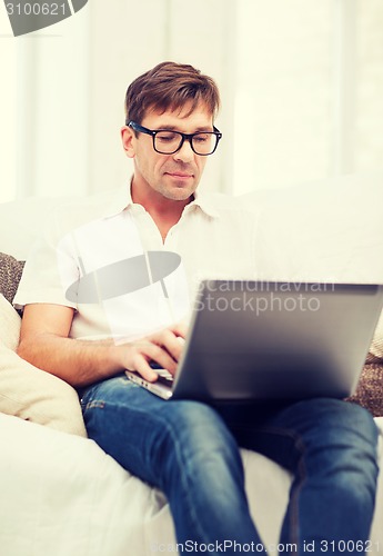 Image of man working with laptop at home