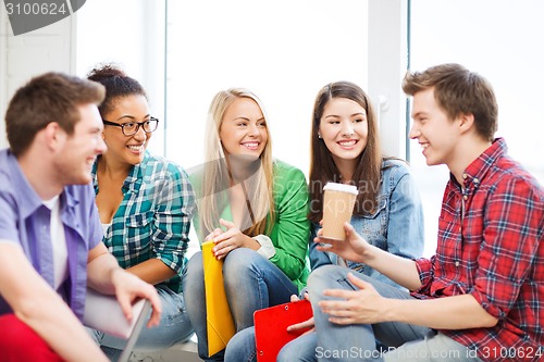 Image of students communicating and laughing at school