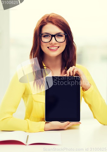 Image of smiling student girl in eyelgasses with tablet pc