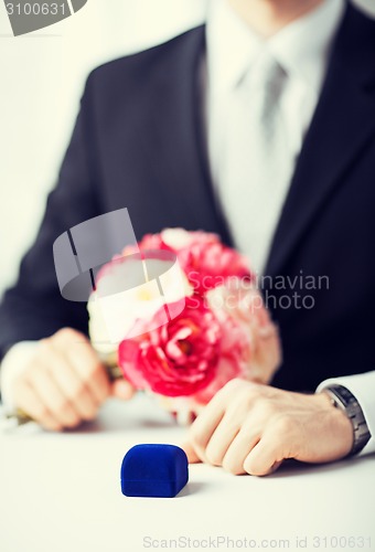 Image of man with gift box in suit