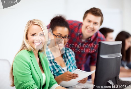 Image of students with computer studying at school