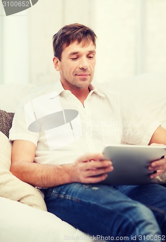 Image of man working with tablet pc at home