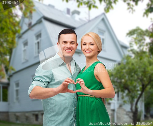 Image of smiling couple and showing heart shape gesture