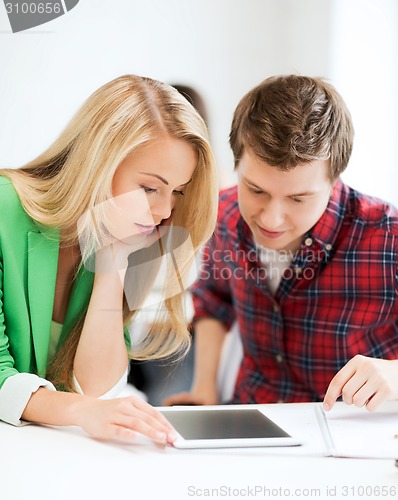 Image of students looking at tablet pc at school