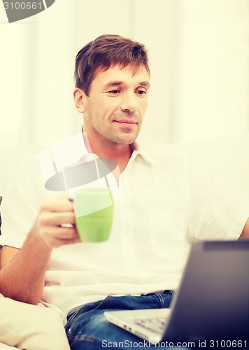 Image of man working with laptop at home