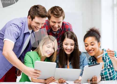 Image of students looking at tablet pc in lecture at school