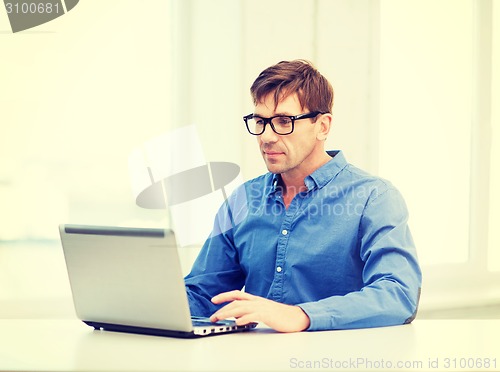 Image of man working with laptop at home