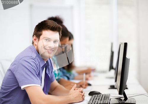 Image of student with computer studying at school