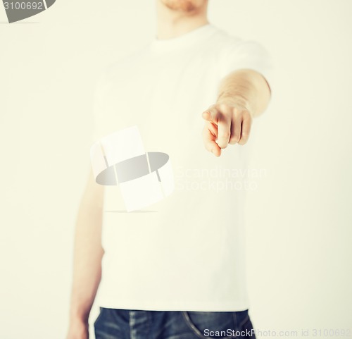 Image of man pointing his finger at you