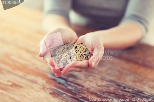 Image of female with white and wild black rice on palm