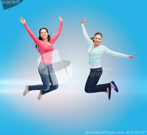 Image of smiling young women jumping in air