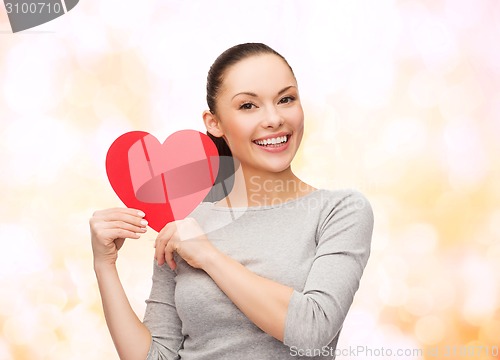 Image of smiling asian woman with red heart