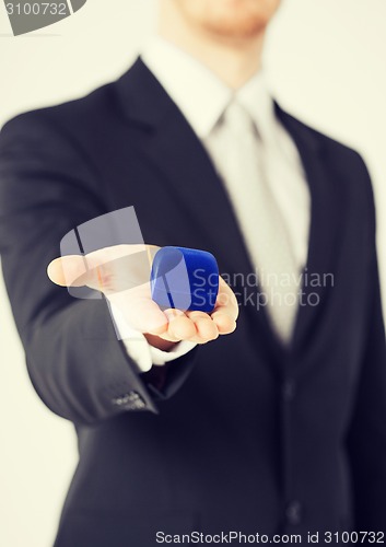 Image of man with gift box in suit