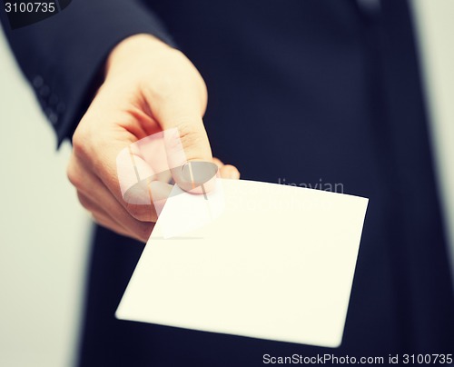 Image of man in suit holding credit card