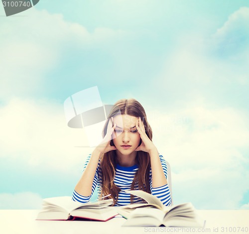 Image of stressed student girl with books