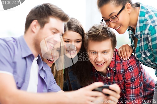 Image of students looking at smartphone at school