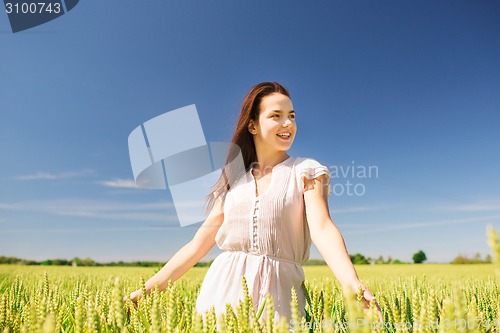 Image of smiling young woman on cereal field