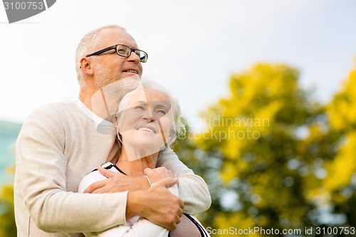 Image of senior couple hugging in park