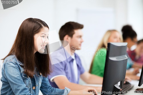 Image of students with computers studying at school