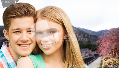 Image of smiling couple over asian landscape background