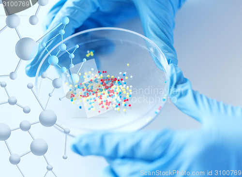 Image of close up of scientist hands holding chemical cure