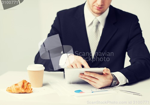 Image of man with tablet pc and cup of coffee