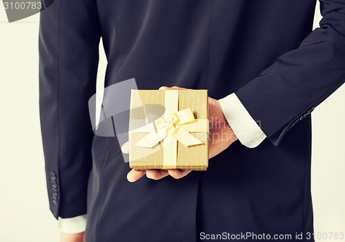 Image of man hands holding gift box