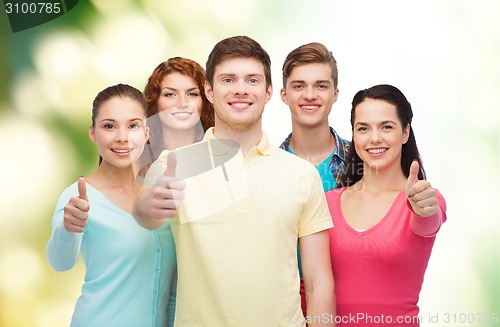 Image of group of smiling teenagers over green background
