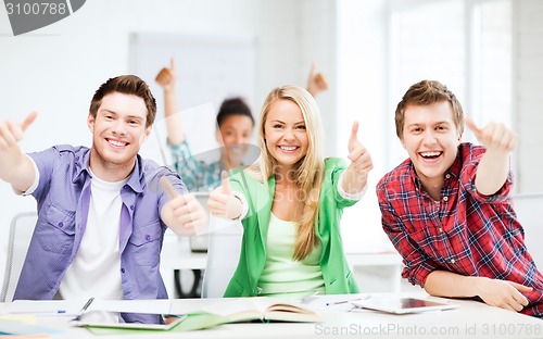 Image of students showing thumbs up at school