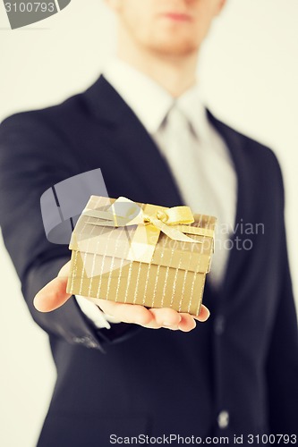 Image of man hands holding gift box