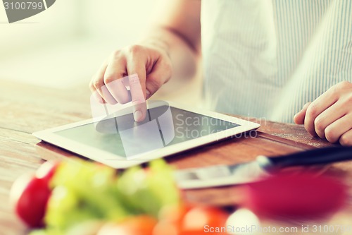 Image of closeup of man pointing finger to tablet pc