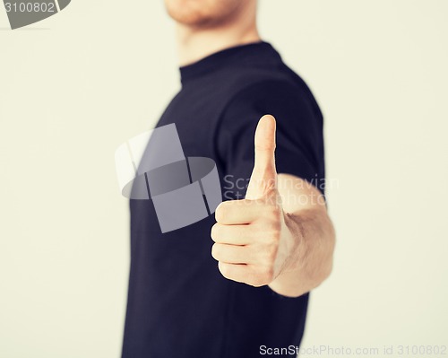 Image of man showing thumbs up